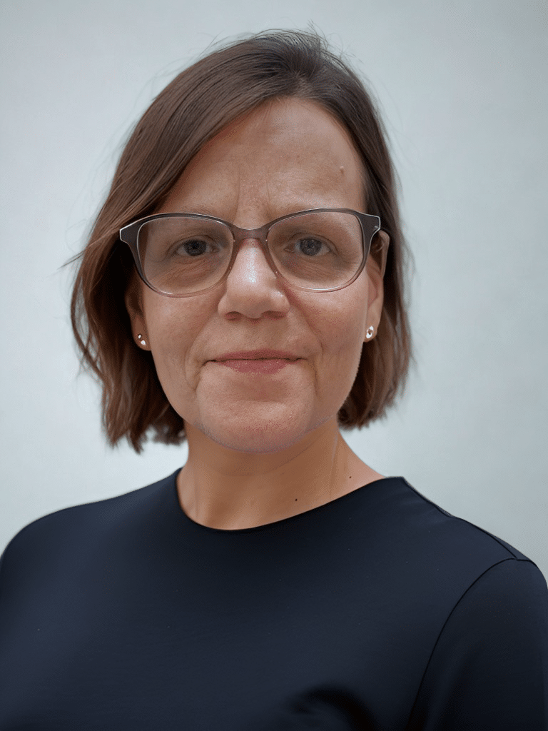 Serena Front Portrait 2025 short hair, glasses, blue top